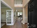 Bright and airy foyer featuring wood floors, high ceilings, and staircase at 9700 Ravenscroft Nw Ln, Concord, NC 28027