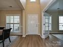 Welcoming foyer with wood floors and a view into the dining area at 9700 Ravenscroft Nw Ln, Concord, NC 28027