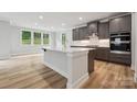 Modern kitchen featuring a large island, stainless steel appliances, and ample cabinet space at 9952 Manor Vista Trl, Kannapolis, NC 28027