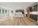 Open-concept kitchen with large island, abundant cabinets, stainless appliances, and hardwood floors at 9952 Manor Vista Trl, Kannapolis, NC 28027