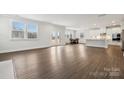 Spacious living area with hardwood floors, large windows, and seamless flow into the kitchen and dining areas at 9952 Manor Vista Trl, Kannapolis, NC 28027