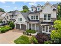 Charming two-story home with a combination of stone and white siding, dormer windows, and a two-car garage at 1012 N Sharon Amity Rd, Charlotte, NC 28211