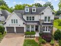 Beautiful two-story home featuring a stone and siding facade, dormer windows, and a two-car garage at 1012 N Sharon Amity Rd, Charlotte, NC 28211