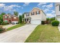 Lovely two-story home with inviting curb appeal, long driveway, and well-kept landscaping at 1105 Bottle Brush Ln, Harrisburg, NC 28075