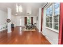 Bright living room with hardwood floors, large windows, and elegant decor at 1105 Bottle Brush Ln, Harrisburg, NC 28075