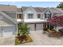 Charming townhome featuring a two-car garage, brick accents, and well-maintained landscaping at 12407 Crowley Ct, Charlotte, NC 28277