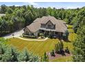Expansive aerial view of a luxury home with lush landscaping and a sprawling lawn, showcasing its peaceful setting at 14010 Mccord Rd, Huntersville, NC 28078