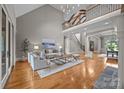 Elegant living room boasting high ceilings, hardwood floors, and a grand staircase for luxurious living at 14010 Mccord Rd, Huntersville, NC 28078