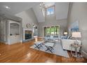 Bright living room features a cozy fireplace, vaulted ceilings, and lots of natural light at 14010 Mccord Rd, Huntersville, NC 28078