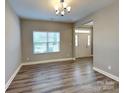 Inviting living area featuring wood-look flooring and natural light, highlighting the home's open-concept design at 15003 Boudins Ln, Charlotte, NC 28278