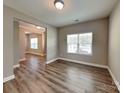 Bright living room showcasing wood floors and a neutral color palette, creating an inviting and modern atmosphere at 15003 Boudins Ln, Charlotte, NC 28278