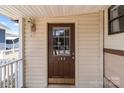 Close-up view of the front door with a window, showing the house number 165 and exterior details at 165 Cardinal Dr # 615, New London, NC 27371