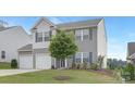 Charming two-story home boasts a well-manicured lawn and an attached two-car garage at 165 Clove Hitch Dr # I281, Statesville, NC 28677