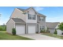 A two-story home showing the driveway and garage with light gray siding, blue shutters, and a gabled roof at 165 Clove Hitch Dr # I281, Statesville, NC 28677