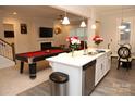 Open-concept kitchen featuring a central island, stainless steel appliances, and an adjacent living space at 1727 Grace Ln, Charlotte, NC 28262