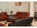 Cozy living room showcasing a leather sofa set, coffee table, and a decorative area rug at 1727 Grace Ln, Charlotte, NC 28262