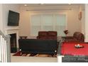 Inviting living room with a fireplace, billiard table, comfortable seating, and natural light at 1727 Grace Ln, Charlotte, NC 28262
