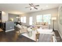 Bright open-concept living room with hardwood floors, lots of natural light, and a view into the dining area at 1809 Evergreen Dr, Charlotte, NC 28208