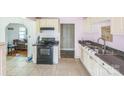 Kitchen featuring tile floors, cream colored cabinets and black appliances at 1908 5Th St, Statesville, NC 28677