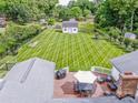 Expansive fenced backyard with a shed and striped lawn, seen from a wooden deck with an umbrella and furniture at 195 Brookfield Cir, Mooresville, NC 28115