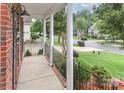 Charming porch with white columns offering a view of the landscaped front yard and quiet street at 212 Forest Walk Way, Mooresville, NC 28115