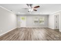 Bright living room with crown molding, ceiling fan, lots of natural light and gray wood-look floors at 2376 S Us 321 Hwy, Newton, NC 28658