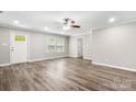 Bright living room with crown molding, ceiling fan, lots of natural light and gray wood-look floors at 2376 S Us 321 Hwy, Newton, NC 28658