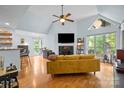 Bright living room with vaulted ceilings, fireplace, large windows, and hardwood floors at 2502 Cranbrook Ln # 8, Charlotte, NC 28207