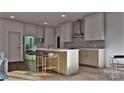 Bright kitchen features a spacious island with seating, stainless steel appliances, and custom cabinetry at 2601 Greenmont Cir, Belmont, NC 28012