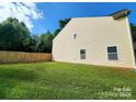 Expansive backyard with lush green grass and a privacy fence, perfect for outdoor activities at 4009 Egrets Nest Ct, Mount Holly, NC 28120