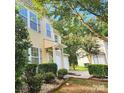 Two-story home with a well-manicured lawn and a two-car garage, surrounded by mature trees at 4009 Egrets Nest Ct, Mount Holly, NC 28120