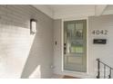 Close-up of the home's stylish front door, showcasing the freshly painted brick and modern lighting fixture at 4042 Uppergate Ln, Charlotte, NC 28215