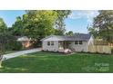 Lovely single-story home with lush green lawn, freshly painted exterior, and newly installed fence at 4042 Uppergate Ln, Charlotte, NC 28215