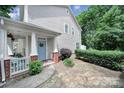 Charming home with a cozy covered front porch, fresh landscaping, and a delightful blue door at 413 Hurston Cir, Charlotte, NC 28208