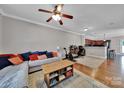 Open living area with hardwood floors, a neutral palette, and a view to the kitchen at 413 Hurston Cir, Charlotte, NC 28208