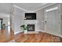 Inviting living room with a cozy fireplace, hardwood floors, and a bright entrance at 413 Hurston Cir, Charlotte, NC 28208