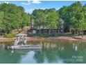 Expansive lake view from the property with a private dock and lush greenery surrounding the home at 495 Bay Harbour Rd, Mooresville, NC 28117