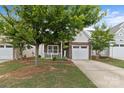 Inviting brick and vinyl home with a tidy front yard and a garage at 5076 Newport Lakes Dr, Rock Hill, SC 29732