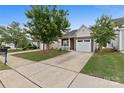Inviting home with a spacious driveway, well-manicured lawn, and mature trees providing shade at 5076 Newport Lakes Dr, Rock Hill, SC 29732