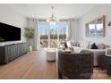 Bright living room with hardwood floors, a stylish sofa, and a walkout to a balcony at 5512 Swaling St, Charlotte, NC 28217