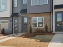 Modern townhome exterior with brick accents, manicured lawn, and inviting entryway at 5517 Swaling St, Charlotte, NC 28217
