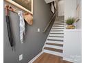Welcoming hallway with coat rack, stylish decor, and staircase leading upstairs at 5517 Swaling St, Charlotte, NC 28217