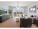 Bright living room with modern furnishings, balcony access, and elegant decor at 5517 Swaling St, Charlotte, NC 28217