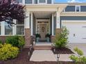 Charming home entrance with a covered porch, brick accents, and beautiful landscaping at 6012 Millbridge Pkwy, Waxhaw, NC 28173