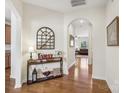 Charming entryway features hardwood floors, elegant console table with decor and an arched doorway at 6315 Prosperity Church Rd, Charlotte, NC 28269