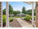 Inviting covered front porch showcasing manicured landscaping and a serene neighborhood view at 6315 Prosperity Church Rd, Charlotte, NC 28269