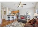 Inviting living room features hardwood floors, a ceiling fan, and a cozy seating area with a comfortable couch at 6315 Prosperity Church Rd, Charlotte, NC 28269