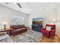 Cozy living room with plush seating, hardwood floors, and a large window providing ample natural light at 6315 Prosperity Church Rd, Charlotte, NC 28269