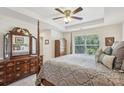 Spacious main bedroom boasts a tray ceiling, large windows, and elegant furniture, creating a serene retreat at 6315 Prosperity Church Rd, Charlotte, NC 28269