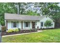 Well-manicured lawn leads to a lovely home, highlighting its inviting facade and landscaping at 6624 Lancer Dr, Charlotte, NC 28226